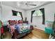 Bright bedroom with hardwood floors and window light at 7101 Alan Dr, Denver, CO 80221