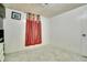 Bedroom with red curtains and dresser offers ample space for relaxation at 7101 Alan Dr, Denver, CO 80221