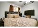 Cozy bedroom with a patterned bedspread, TV, and neutral decor for a relaxing atmosphere at 7101 Alan Dr, Denver, CO 80221