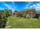 The well-maintained exterior showcases the charming brick accents, lush lawn, and mature landscaping at 7101 Alan Dr, Denver, CO 80221