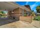 Exterior shot of home with red brick, porch, and attached carport at 7101 Alan Dr, Denver, CO 80221