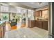 A spacious kitchen flows into a living area, with tiled floors and abundant natural light at 7101 Alan Dr, Denver, CO 80221