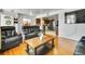 A flowing open floor plan connects the living area and kitchen for easy entertaining at 7101 Alan Dr, Denver, CO 80221