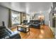 Inviting living room offers ample seating and natural light, seamlessly connecting to the dining area at 7101 Alan Dr, Denver, CO 80221