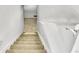 Carpeted staircase with white walls and a white handrail at 7101 Alan Dr, Denver, CO 80221