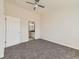 Bedroom features soft carpet, fan, and access to the bathroom at 15217 Xenia St, Thornton, CO 80602