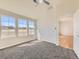 Bedroom with large windows offering neighborhood views and soft carpeting at 15217 Xenia St, Thornton, CO 80602