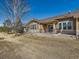 Back of house with patio and view of golf course at 15217 Xenia St, Thornton, CO 80602