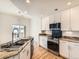 Bright kitchen features granite countertops, stainless steel appliances, and backsplash at 15217 Xenia St, Thornton, CO 80602