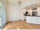 Bright living room and kitchen with modern lighting and hardwood floors at 15217 Xenia St, Thornton, CO 80602