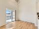 Well-lit living room and kitchen feature modern lighting and a sliding glass door to the backyard at 15217 Xenia St, Thornton, CO 80602