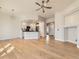 Inviting open concept layout of living room and kitchen with hardwood floors at 15217 Xenia St, Thornton, CO 80602