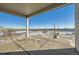 Covered patio with checkered concrete and distant views at 9880 E 160Th Pl, Brighton, CO 80602