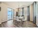 Bright dining room with a glass table, white chairs, and access to a deck at 9880 E 160Th Pl, Brighton, CO 80602