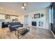 Living room with hardwood floors, gray sofas, and a fireplace at 9880 E 160Th Pl, Brighton, CO 80602