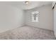 Bedroom with neutral carpet, white walls, and a view of the exterior at 8858 Waterleaf Ln, Littleton, CO 80125