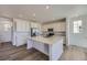 Modern kitchen features stainless steel appliances and a center island with quartz countertops at 8858 Waterleaf Ln, Littleton, CO 80125