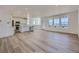 Open concept living space with large windows, hardwood floors, and a kitchen island at 8858 Waterleaf Ln, Littleton, CO 80125