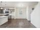 Bright dining area with hardwood floors, modern lighting, and access to kitchen with stainless appliances at 1638 Plata St, Lochbuie, CO 80603