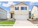 Charming two-story home featuring a two-car garage and a well-manicured lawn on a sunny day at 1638 Plata St, Lochbuie, CO 80603