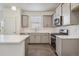 Well-equipped kitchen with gray cabinets, stainless steel appliances, white countertops and backsplash at 1638 Plata St, Lochbuie, CO 80603