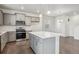 Modern kitchen featuring stainless appliances, light gray cabinets, and an island with seating at 1638 Plata St, Lochbuie, CO 80603