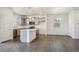 Modern kitchen featuring stainless appliances, light gray cabinets, and an island with seating at 1638 Plata St, Lochbuie, CO 80603