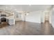 Open-concept living area with hardwood floors, kitchen island, and neutral wall colors at 1638 Plata St, Lochbuie, CO 80603