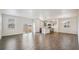 Bright, open floorplan showcasing wood floors, a modern kitchen, and a spacious living area at 1638 Plata St, Lochbuie, CO 80603