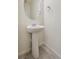 Clean powder room featuring a pedestal sink, tile flooring and modern fixtures at 1638 Plata St, Lochbuie, CO 80603