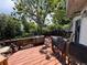 Elevated view of the wooden back deck with a scenic view of the yard and surrounding greenery at 1843 S Urban Way, Lakewood, CO 80228