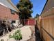 View of a fenced backyard with a pile of building supplies at 1843 S Urban Way, Lakewood, CO 80228
