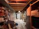 Basement includes a water heater, unfinished ceilings, and storage shelving at 1843 S Urban Way, Lakewood, CO 80228