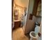 This bathroom has a toilet, sink, vanity, a shower with glass doors, and built-in shelving at 1843 S Urban Way, Lakewood, CO 80228