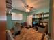 Functional bedroom/office space with window, ceiling fan, storage shelves, and office furniture at 1843 S Urban Way, Lakewood, CO 80228