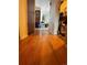 Hallway featuring hardwood floors connecting the various spaces of the home, with view of rooms at the end at 1843 S Urban Way, Lakewood, CO 80228