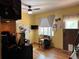 This yellow living room includes wood look floors, a window with curtains, and a ceiling fan with light at 1843 S Urban Way, Lakewood, CO 80228