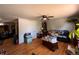 Cozy living room featuring wood floors, ceiling fan, and neutral walls, ready for personalization at 1843 S Urban Way, Lakewood, CO 80228