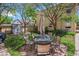 Picturesque backyard with stone patio, table and chairs, and mature trees at 1580 N Franklin St, Denver, CO 80218