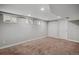 Spacious basement with neutral walls, carpet flooring, and closet doors at 1580 N Franklin St, Denver, CO 80218
