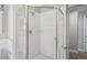 Bathroom featuring a sleek glass shower with white tiled walls at 1580 N Franklin St, Denver, CO 80218