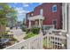 Red brick home with a white pillar-supported porch and landscaped front yard at 1580 N Franklin St, Denver, CO 80218