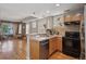 Open concept kitchen view highlighting wood cabinets, and seamless integration with living area at 1580 N Franklin St, Denver, CO 80218