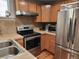 Cozy kitchen features stainless steel appliances, wood cabinets, and ample counter space at 1580 N Franklin St, Denver, CO 80218