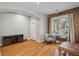 Inviting living area showcasing hardwood floors, exposed brick wall, and ample natural light at 1580 N Franklin St, Denver, CO 80218