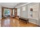 Bright living space highlighting exposed brick, hardwood floors, and large windows at 1580 N Franklin St, Denver, CO 80218