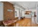Spacious living area featuring hardwood floors, exposed brick wall, and seamless flow to the kitchen at 1580 N Franklin St, Denver, CO 80218