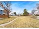 Community park with grassy lawns, playground equipment, and mature trees at 7999 Chase Cir # 31, Arvada, CO 80003