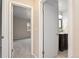 Hallway view to a bedroom and a bathroom with a dark wood vanity cabinet at 7999 Chase Cir # 31, Arvada, CO 80003