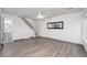 Bright living room showing stairs, bathroom, and entry, illuminated by a modern ceiling fan at 7999 Chase Cir # 31, Arvada, CO 80003